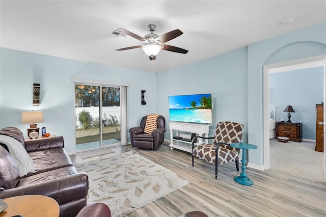 living room featuring ceiling fan and light wood-type flooring