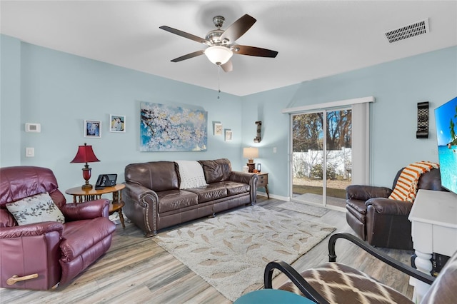 living room featuring ceiling fan and light hardwood / wood-style floors