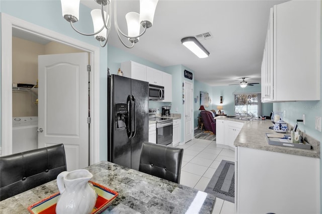 kitchen featuring white cabinetry, pendant lighting, light tile patterned floors, ceiling fan with notable chandelier, and appliances with stainless steel finishes