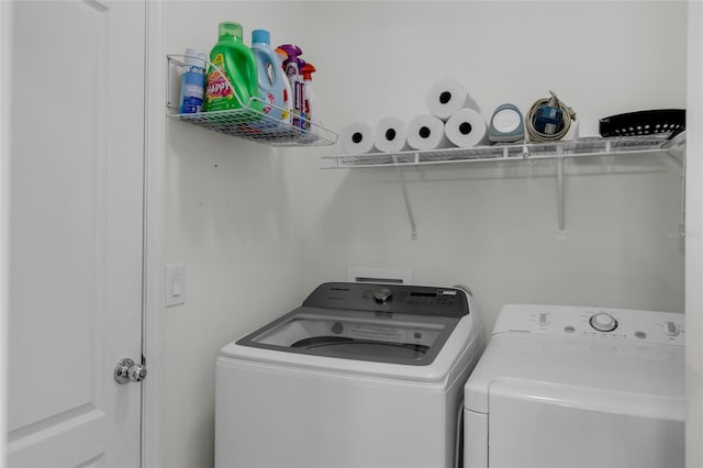 clothes washing area featuring washer and dryer