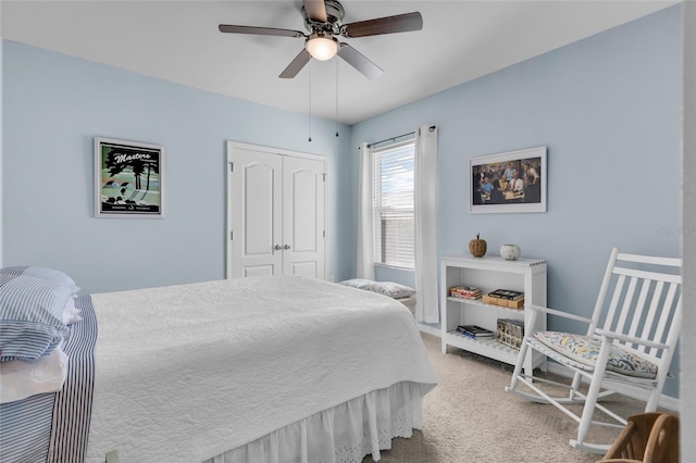 bedroom with a closet, ceiling fan, and light colored carpet