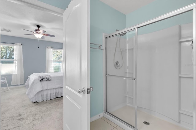 bathroom with ceiling fan and an enclosed shower