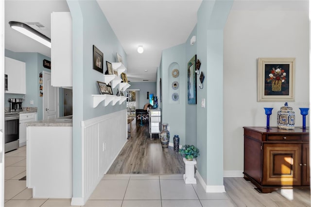 2354 Valhalla Dr, Tavares, FL 32778 - corridor featuring light tile patterned floors and arched walkways