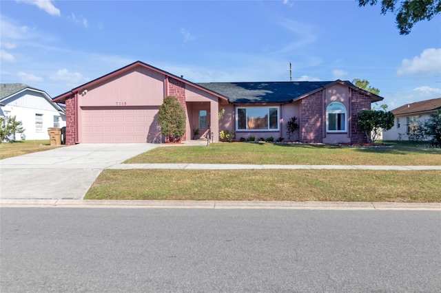 ranch-style home with a front lawn and a garage