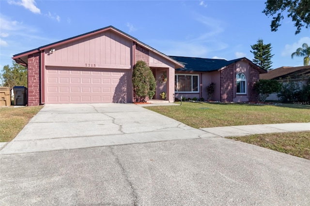 ranch-style home with a front yard and a garage