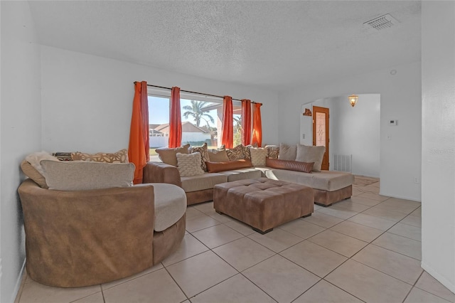 living room with light tile patterned flooring and a textured ceiling