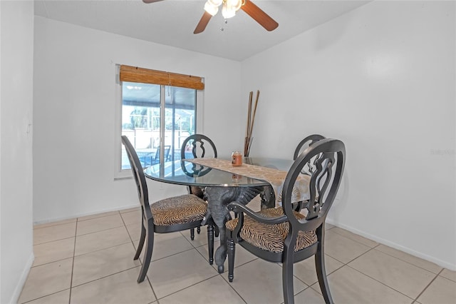 tiled dining area featuring ceiling fan