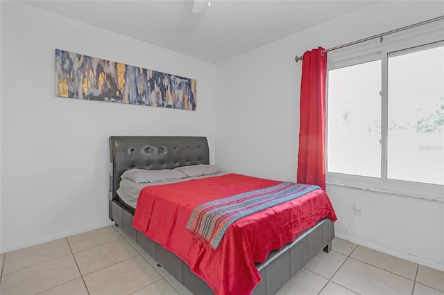 tiled bedroom featuring ceiling fan