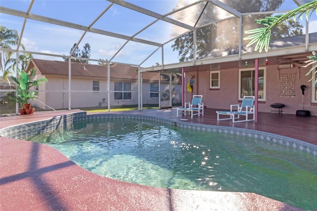 view of pool with glass enclosure, ceiling fan, and a patio