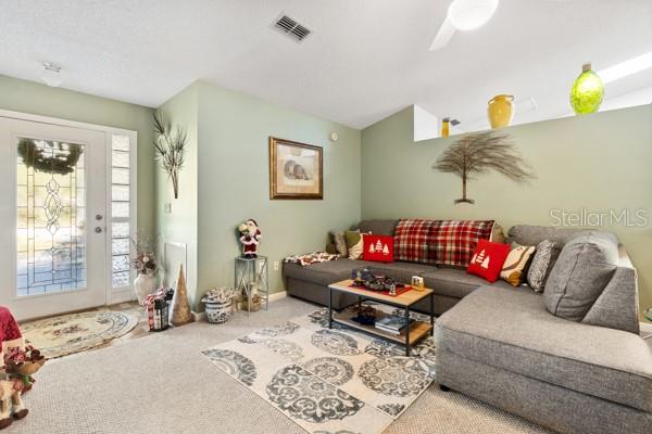 living room with vaulted ceiling and carpet flooring