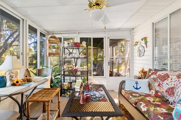 sunroom / solarium with ceiling fan and a healthy amount of sunlight