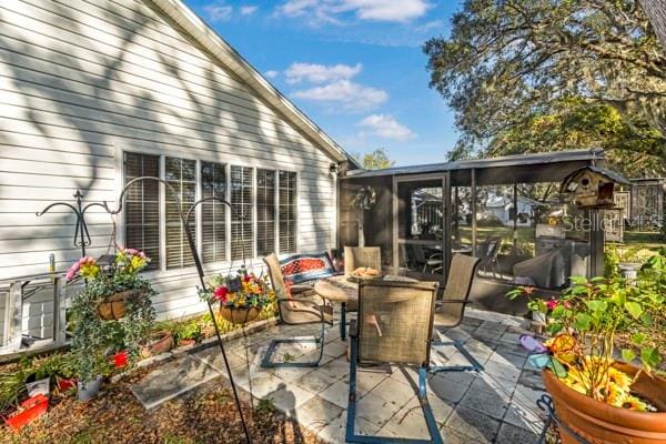 view of patio / terrace featuring a sunroom