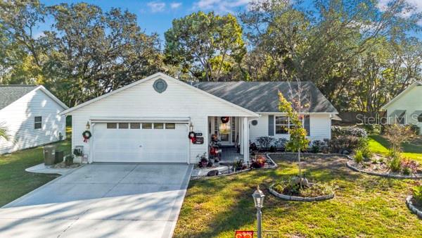 ranch-style house with a front lawn and a garage