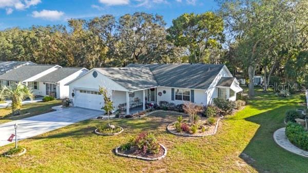 ranch-style house featuring a front lawn and a garage