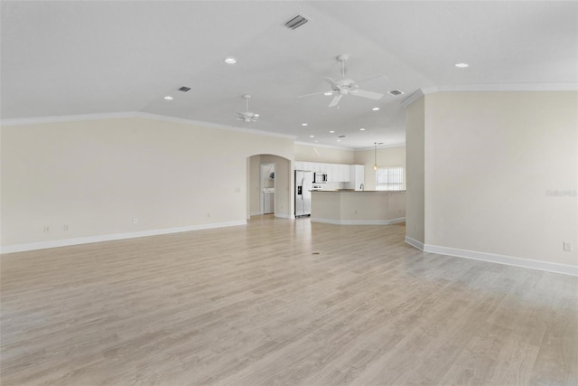 unfurnished living room featuring light wood-type flooring, vaulted ceiling, ceiling fan, and ornamental molding