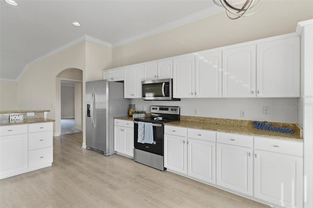 kitchen with stainless steel appliances, ornamental molding, stone countertops, white cabinets, and light wood-type flooring