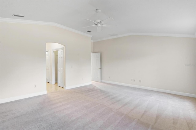 unfurnished room featuring crown molding, light carpet, and vaulted ceiling