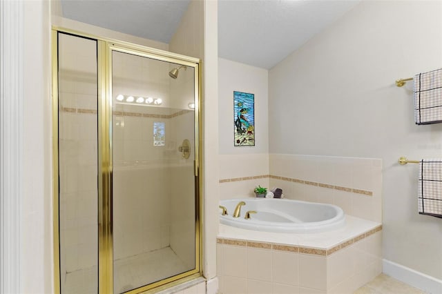 bathroom with independent shower and bath and a textured ceiling