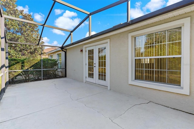 view of patio featuring a lanai and french doors