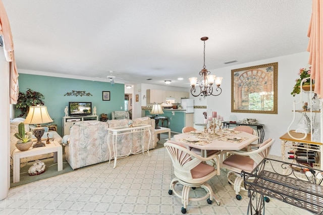 carpeted dining room featuring ceiling fan with notable chandelier and ornamental molding