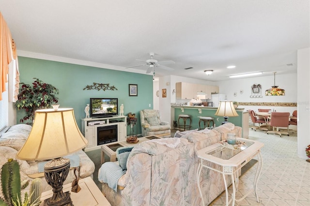 living room featuring light carpet, ceiling fan, and ornamental molding