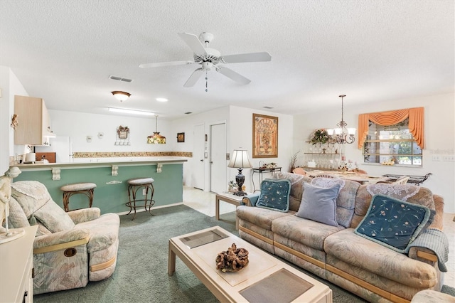 carpeted living room with ceiling fan with notable chandelier and a textured ceiling