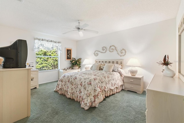 carpeted bedroom featuring a textured ceiling and ceiling fan