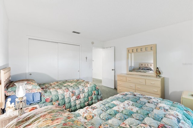 carpeted bedroom featuring a closet