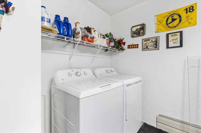 clothes washing area featuring washer and dryer and a baseboard heating unit