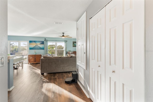 living room featuring dark hardwood / wood-style floors and ceiling fan