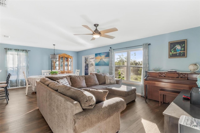 living room featuring dark hardwood / wood-style flooring and ceiling fan