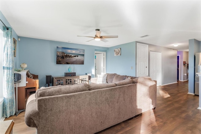 living room with ceiling fan and hardwood / wood-style flooring