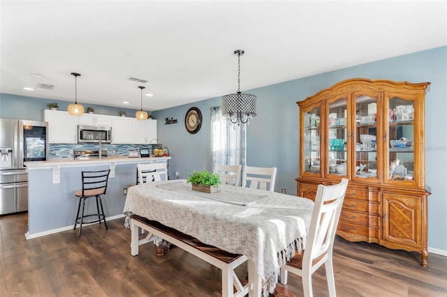 dining area with dark hardwood / wood-style floors