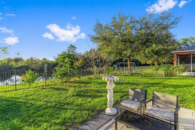 view of yard with a playground and a water view