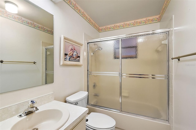 full bathroom featuring shower / bath combination with glass door, vanity, and toilet