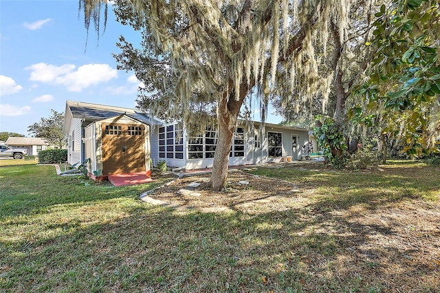 back of house featuring a yard