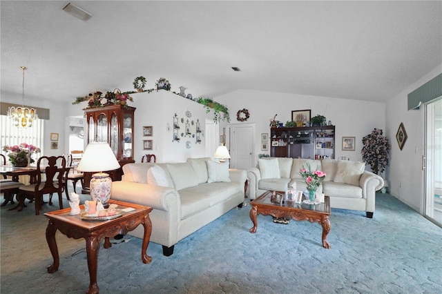 living room featuring carpet flooring, lofted ceiling, and a notable chandelier