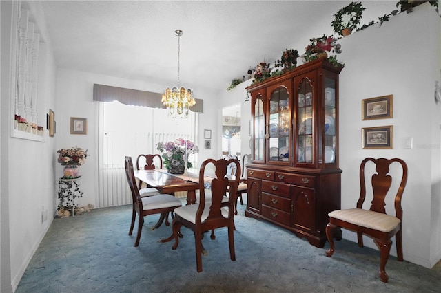 carpeted dining space featuring a notable chandelier