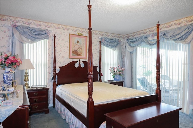 bedroom featuring a textured ceiling and dark carpet