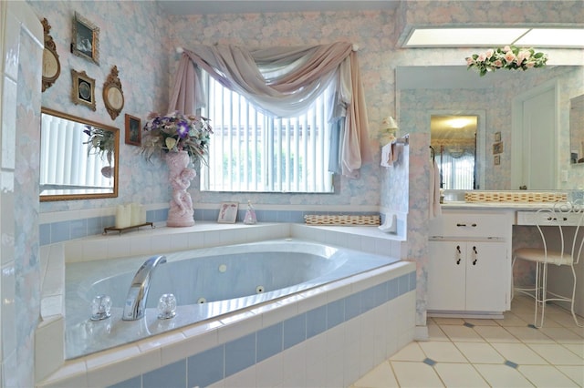 bathroom with tile patterned floors, a relaxing tiled tub, and vanity