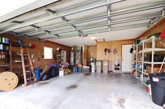 garage featuring wooden walls and gas water heater