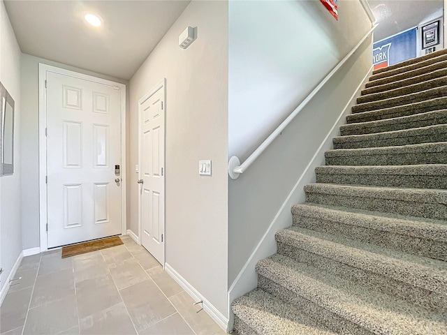 stairway with tile patterned flooring