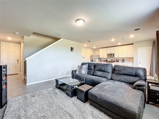 tiled living room with a textured ceiling