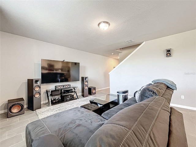 tiled living room featuring a textured ceiling