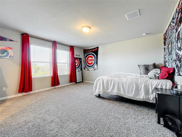 carpeted bedroom featuring a textured ceiling