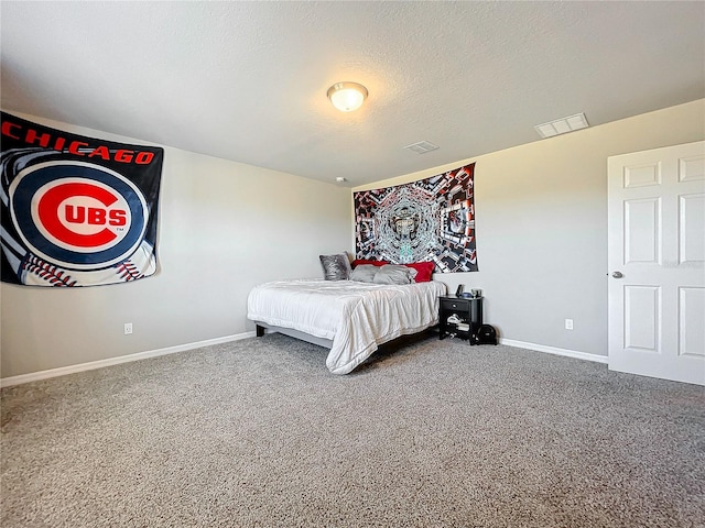 bedroom with carpet floors and a textured ceiling