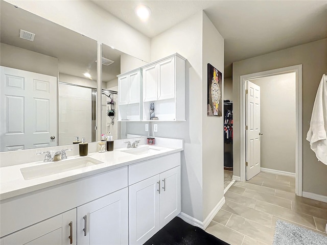 bathroom featuring a shower, vanity, and tile patterned flooring