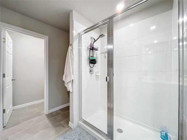 bathroom featuring a shower with door