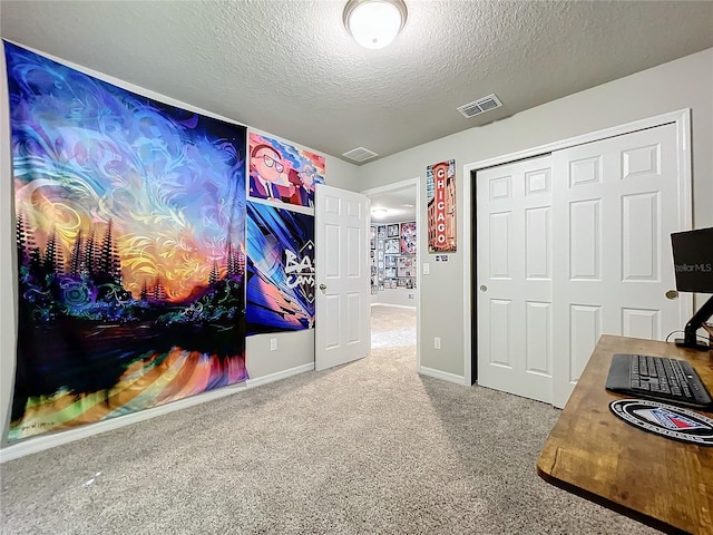 office with carpet and a textured ceiling