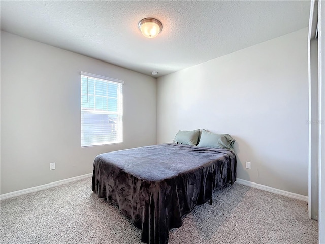 carpeted bedroom with a textured ceiling